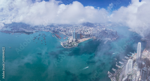 Photography Epic aerial view of the Victoria Harbour in a clear day, with thick cloud and su