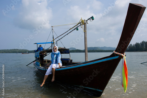 Travelers thai women passenger journey by local wooden long tail boat trip for travel visit Thale Waek San Lang Mangkorn or Separated Sea on Laem Tae Pan in Pak Bara at La ngu city in Satun, Thailand © tuayai