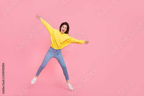 Full body photo of young cheerful woman have fun jumper fly wear casual outfit isolated over pink color background