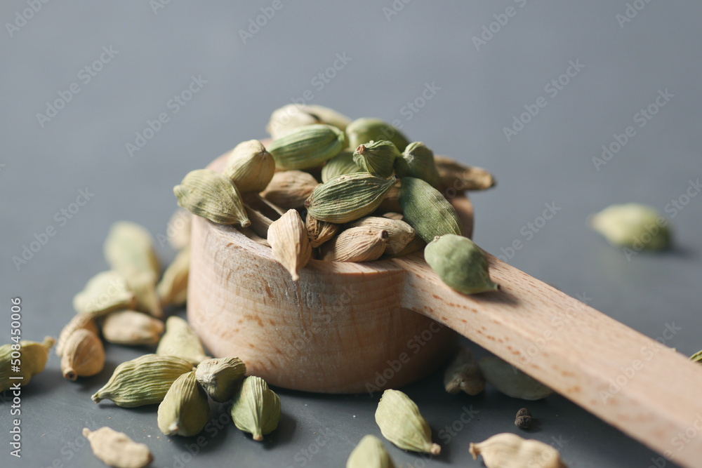 close up of Cardamom on a spoon on table close up of Cardamom on a spoon on table