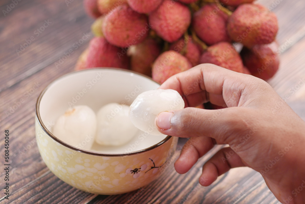 taking skin off from a Lychee fruit taking skin off from a Lychee fruit