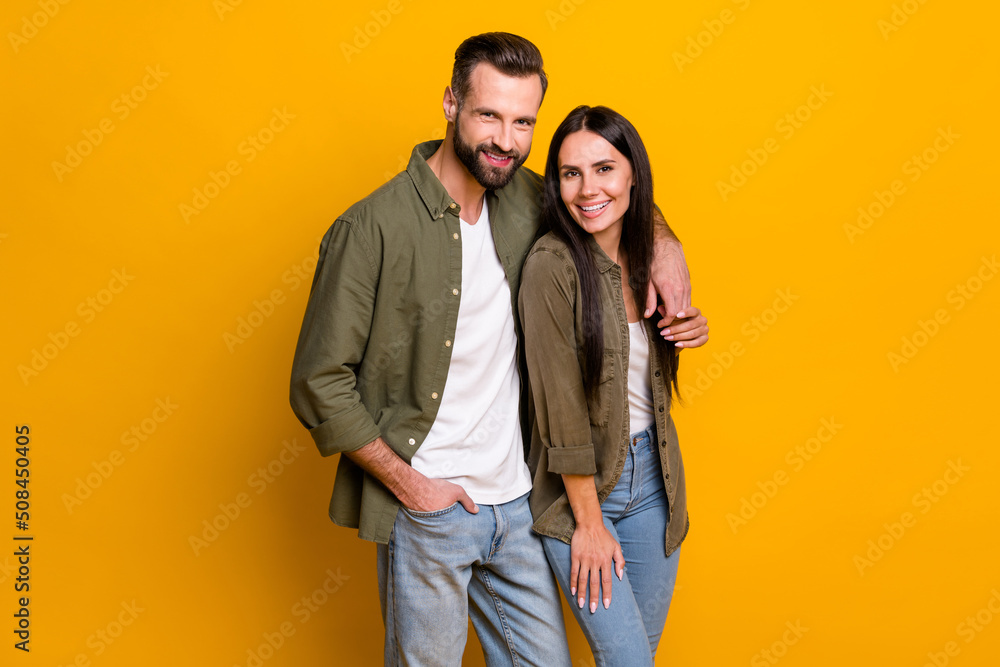 Photo of two young husband wife cuddle spouses soulmate dream romance isolated over yellow color background Photo of two young husband wife cuddle spouses soulmate dream romance isolated over yellow color background