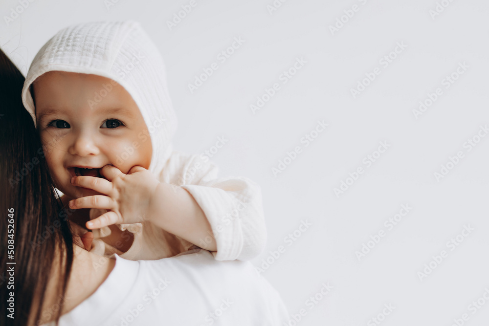 cute studio portrait of a little newborn girl posing for a photo in her mother's arms cute studio portrait of a little newborn girl posing for a photo in her mother's arms