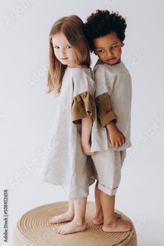 Bild auf Leinwand Photos of children having fun and posing for a photo in summer linen clothes in a photo studio