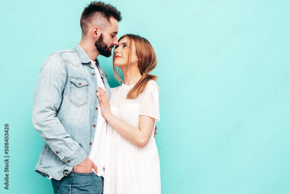 Sexy smiling beautiful woman and her handsome boyfriend. Happy cheerful family having tender moments near blue wall in studio.Pure cheerful models hugging.Embracing each other. Cheerful and happy Sexy smiling beautiful woman and her handsome boyfriend. Happy cheerful family having tender moments near blue wall in studio.Pure cheerful models hugging.Embracing each other. Cheerful and happy