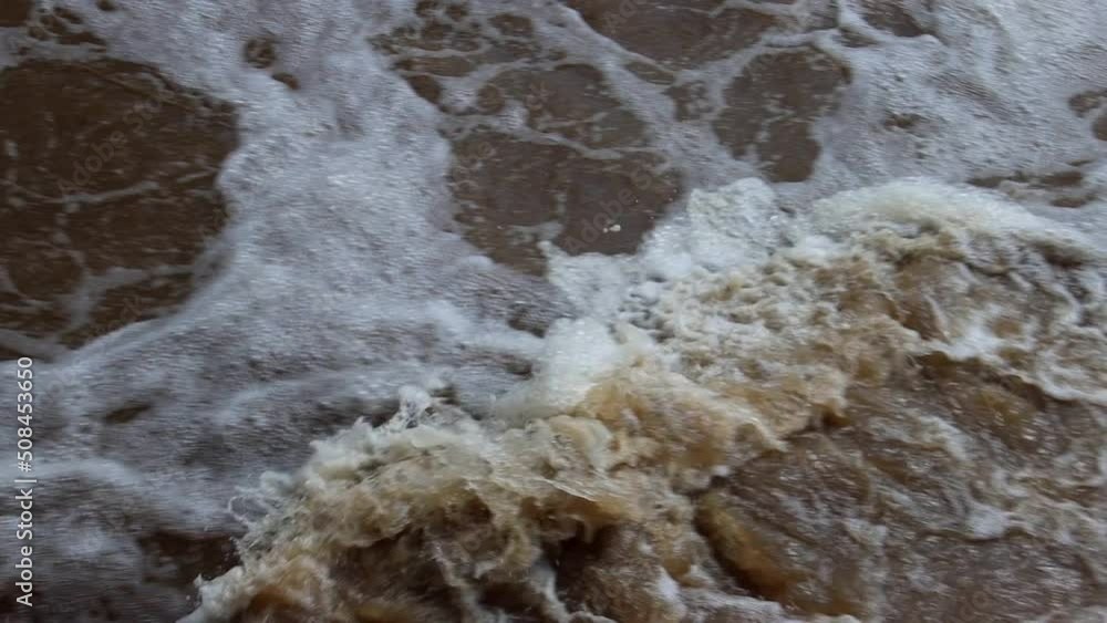Fast flowing water creating a diagonal breaking wave Fast flowing water creating a diagonal breaking wave
