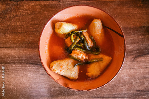 Corundas en salsa roja con chile poblano y carne de cerdo  photo