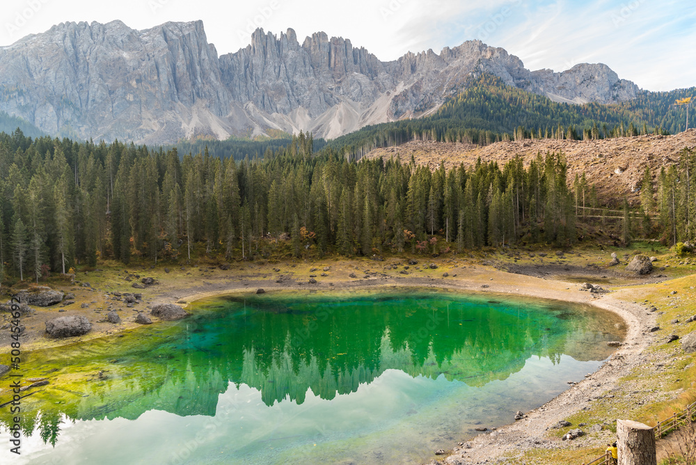 View of a small alpine Lake Carezza o Karersee located in Nova Levante, province of Bolzano in Dolomites, South Tyrol, Italy