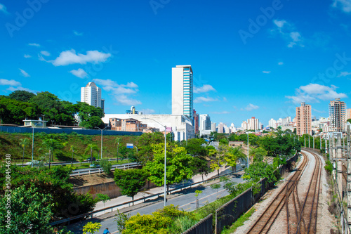 Residential panorama with buildings, trees, blue sky, railway, clouds in the city of Belo Horizonte.
