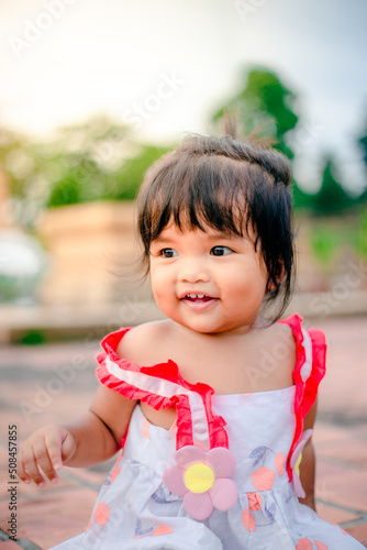 happy little asian girl cheerful with big smile in park funny adorable