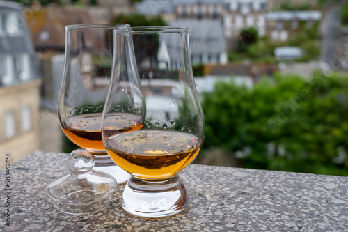 Two glasses of scotch whiskey with view on old houses on background, Edinburgh whisky tasting tour, Scotland © barmalini