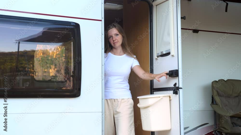 The unhappy angry girl walks out from camper van to the uninvited guests. Road Conflict. Problem in travel trip. The unhappy angry girl walks out from camper van to the uninvited guests. Road Conflict. Problem in travel trip.