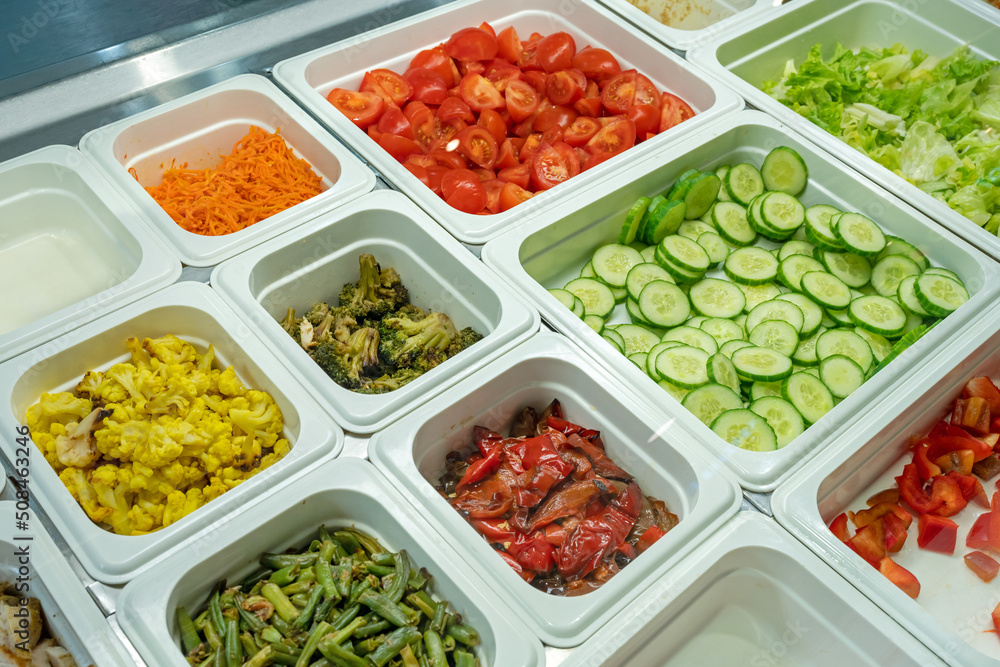 Fresh salad bar with various fresh assortment of ingredients. Display space of options for choice of clients in supermarket or restaurant Fresh salad bar with various fresh assortment of ingredients. Display space of options for choice of clients in supermarket or restaurant