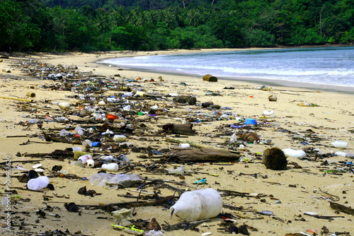 spiled..garbage on the beach  of the big city. Empty used dirty plastic bottles.Dirty sea sandy shore the Black sea.  photo