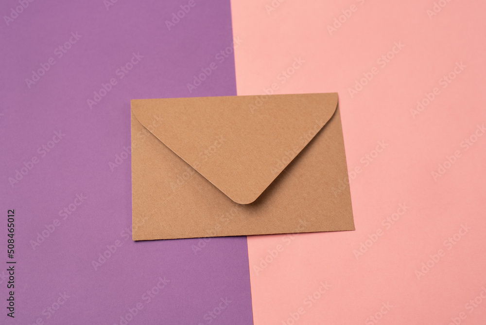 Craft envelope on a two-colored pink and purple background. Craft envelope on a two-colored pink and purple background.