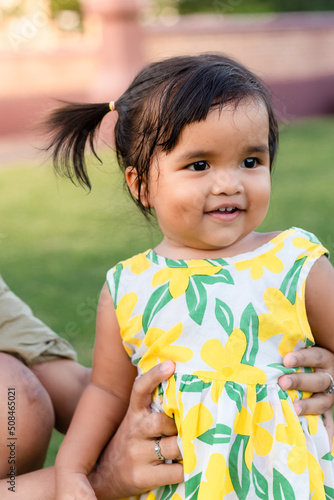 happy little asian girl cheerful with big smile in park funny adorable with mother