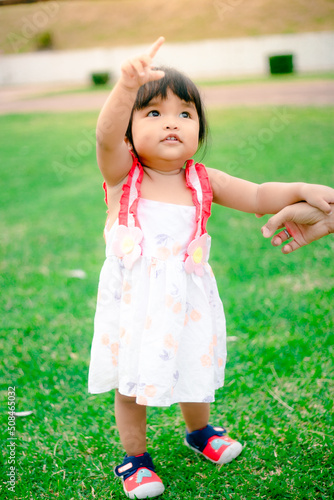 happy little asian girl cheerful with big smile in park funny adorable with mother