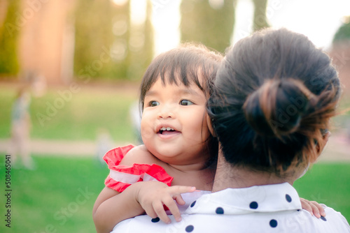 happy little asian girl cheerful with big smile in park funny adorable with mother
