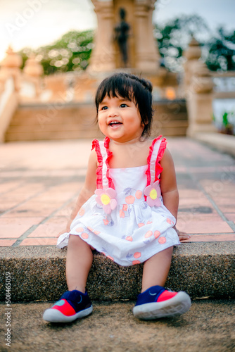happy little asian girl cheerful with big smile in park funny adorable