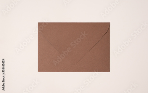 Closed brown envelope on a light background of a milky color