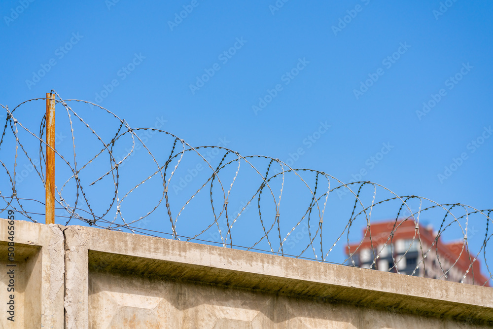 Fototapeta premium Barbed wire in the prison. Restriction of freedom.