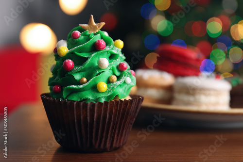 Christmas tree shaped cupcake on wooden table indoors, closeup. Space for text