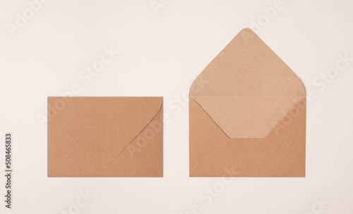 Closed and open craft envelope on light background of a milky color