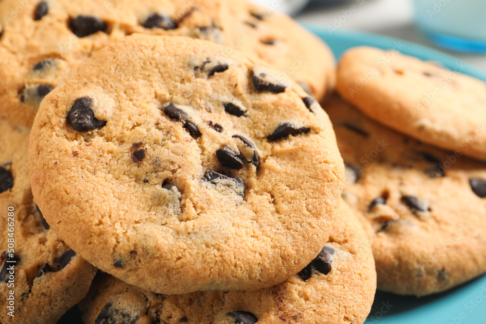Many delicious chocolate chip cookies on plate, closeup Many delicious chocolate chip cookies on plate, closeup