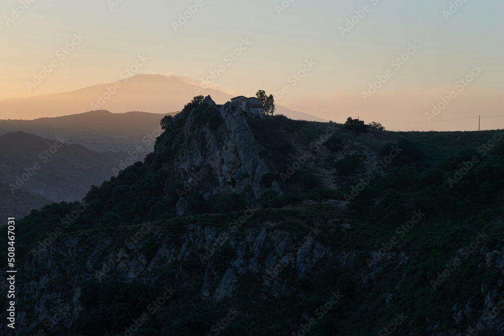 the Etna volcano in the background from the Nebrodi mountains at the first light of dawn the Etna volcano in the background from the Nebrodi mountains at the first light of dawn