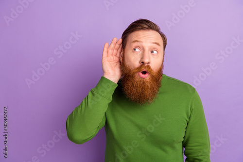 Portrait of attractive curious funny guy listening info copy space advert sale isolated over bright violet lilac color background photo