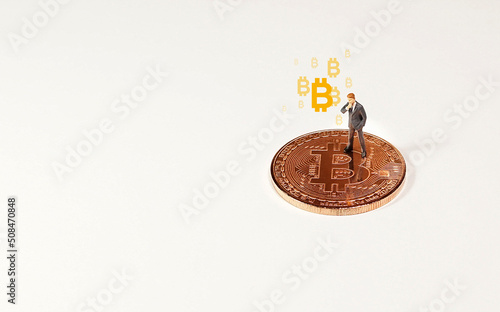 Business man figure standing on bitcoin. Bitcoin mining concept.