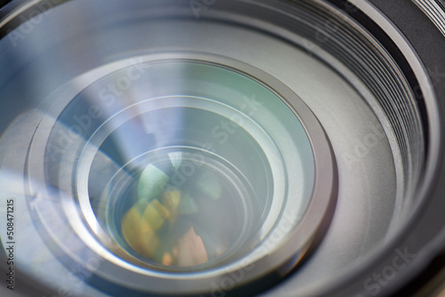 Camera lens with reflection, macro photo, close-up.