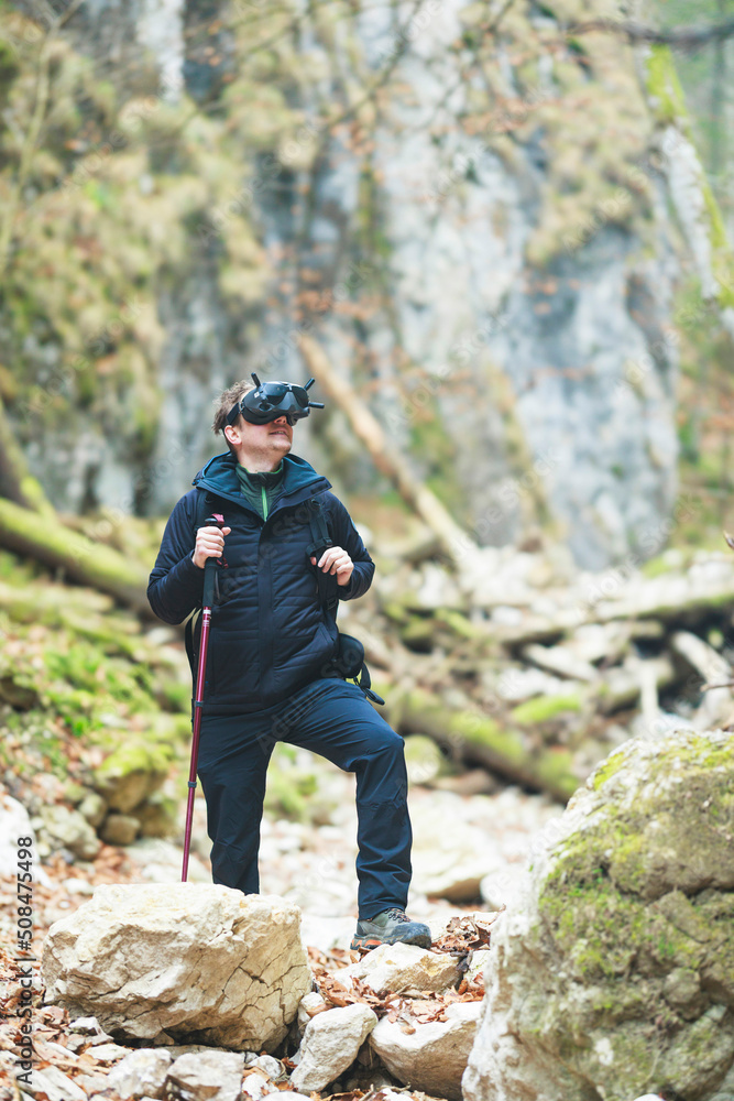 Traveling in universes from metaverse or multiverse using VR glasses latest trends for mountain tourists, go on a virtual hike in nature. Travelling in imaginary world is engaging and stimulating