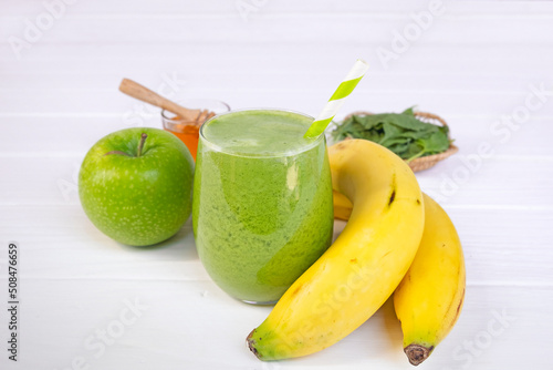 Banana mix apple fresh cocktail vanilla smoothies  fruit juice beverage healthy the taste yummy in glass drink episode good morning on wooden background from the top view.