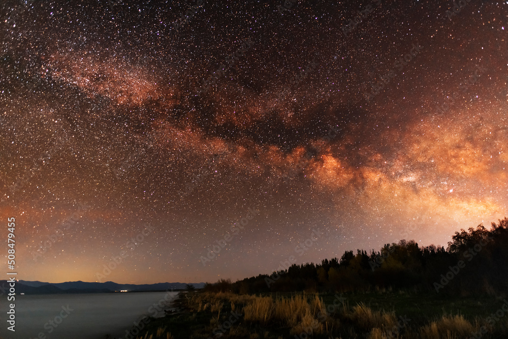 Fototapeta premium Beautiful night landscape milky way galaxy at the night sky over the lake.