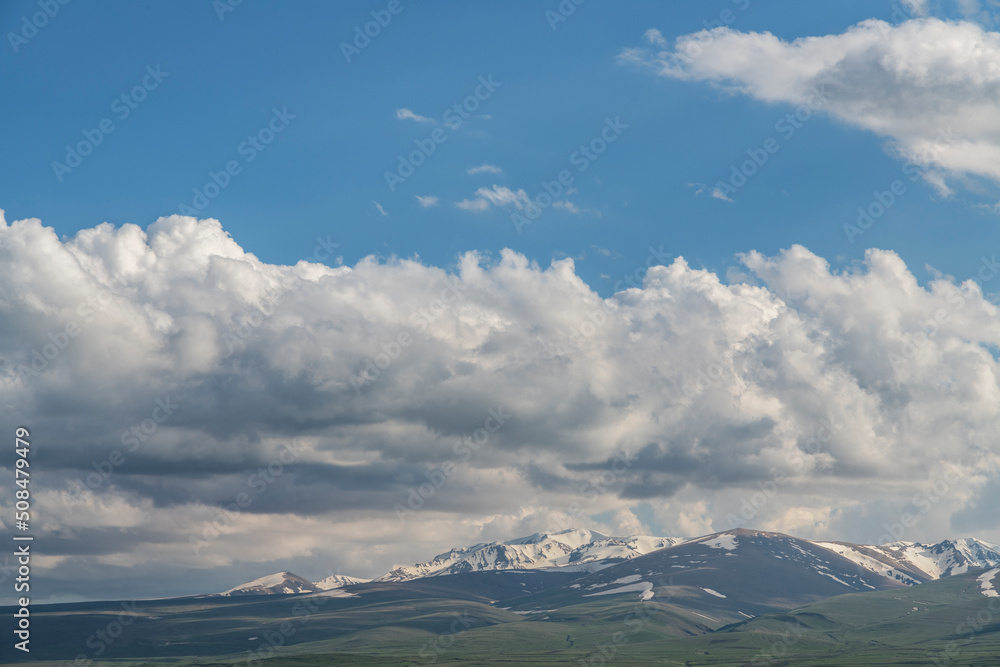 Obraz premium Beautiful mountains landscape. Mountains green hills, clouds on the blue sky