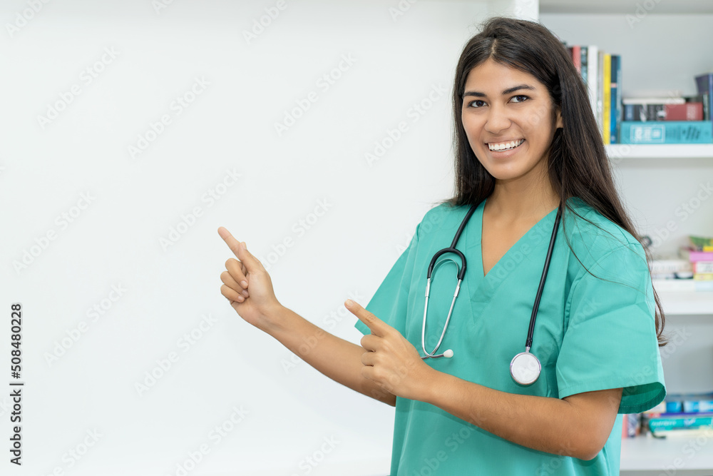 South american female nurse or doctor pointing sideways South american female nurse or doctor pointing sideways
