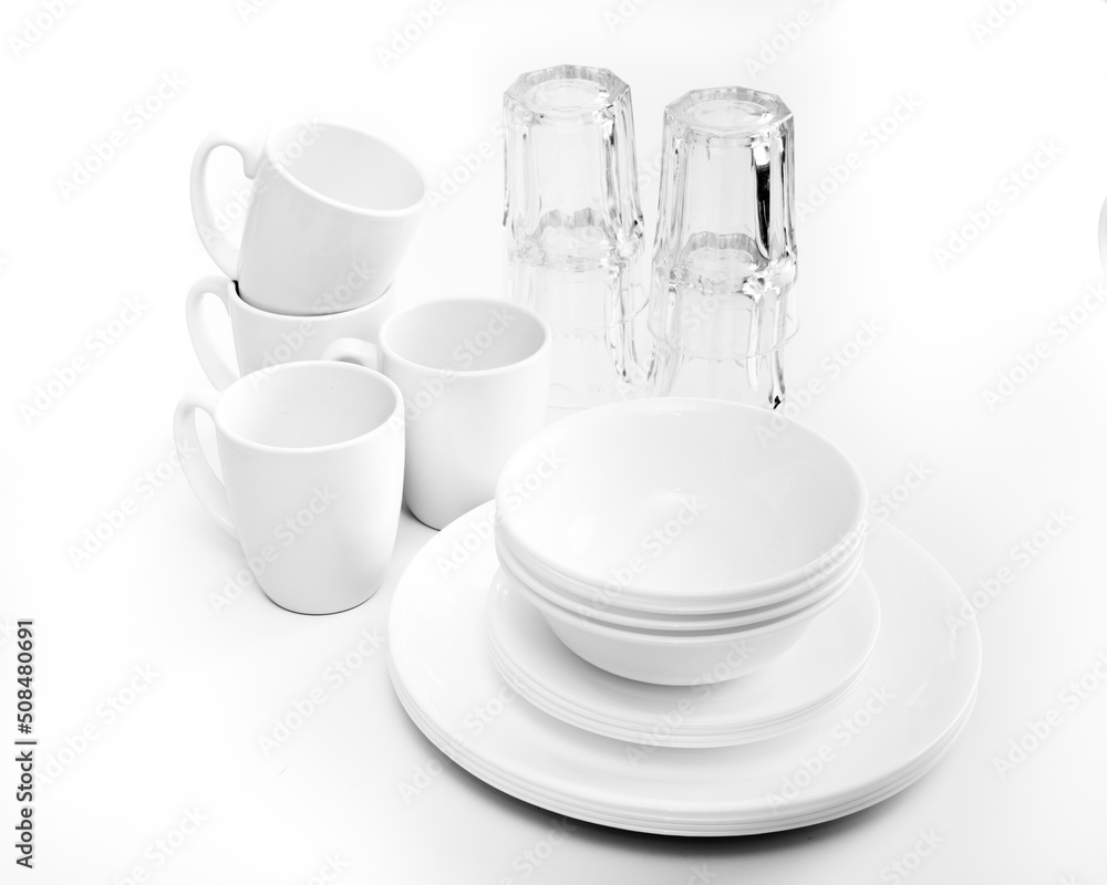 white crockery drying on white plastic rack on white background white crockery drying on white plastic rack on white background