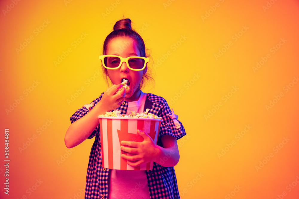 One surprised little girl, pupil wearing 3d glasses and holding bucket