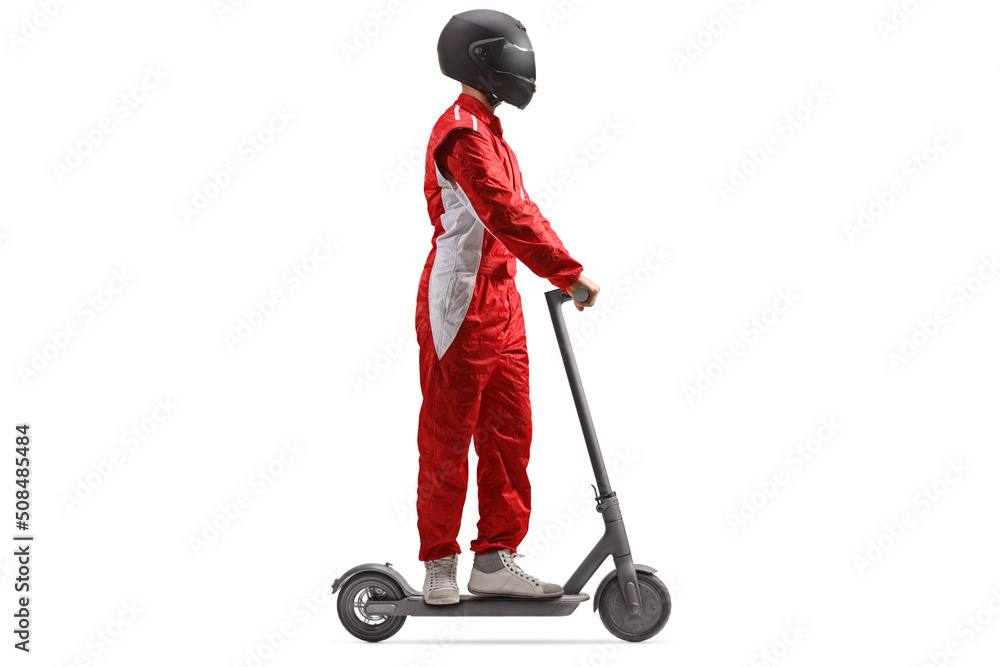 Full length profile shot of a racer in a red suit with a helmet riding an electric scooter Full length profile shot of a racer in a red suit with a helmet riding an electric scooter