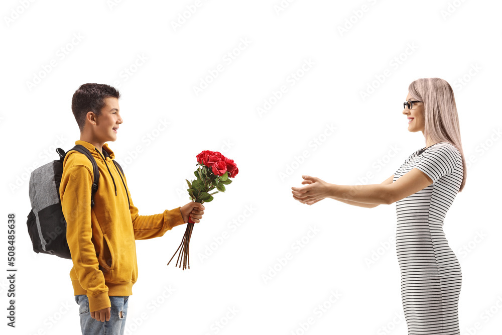Schoolboy giving a bunch of red roses to a woman Schoolboy giving a bunch of red roses to a woman