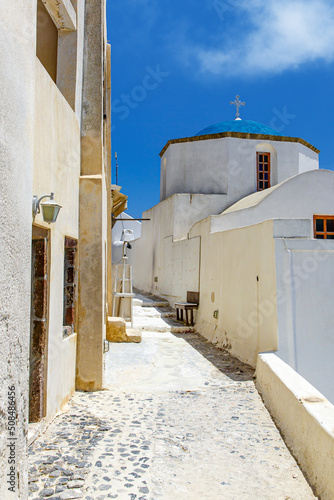 Walking through Santorini streets. Traditional Greek white houses architecture.