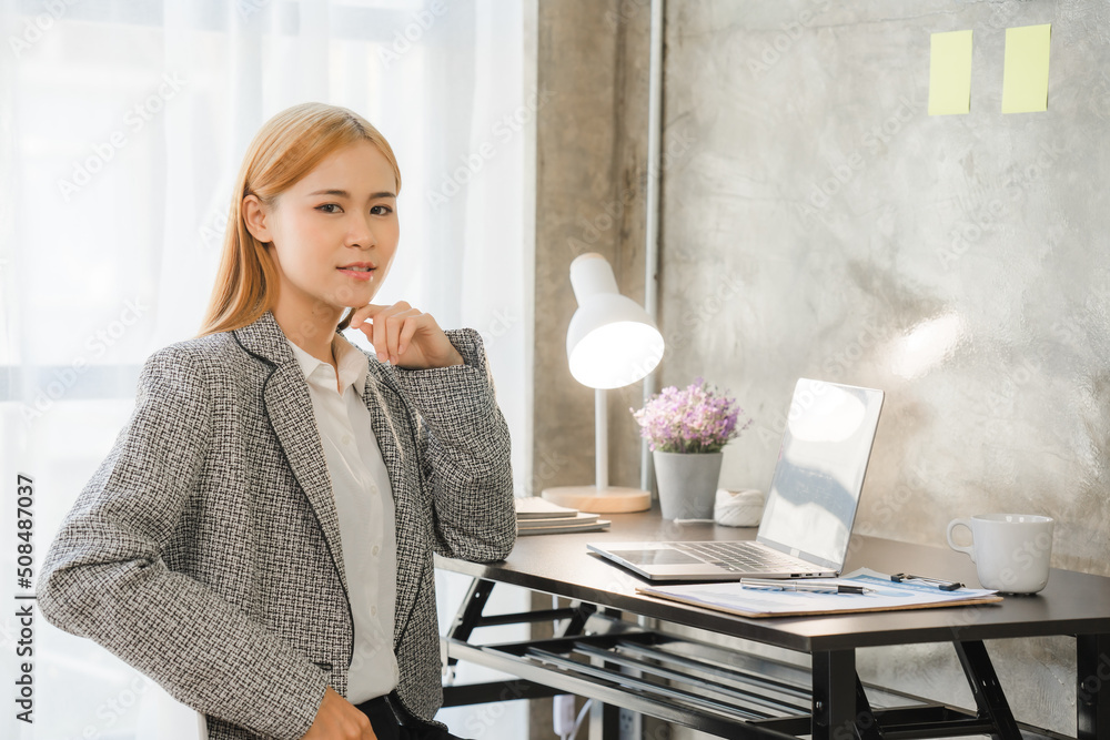 Portrait of Asian young female working on laptop at office