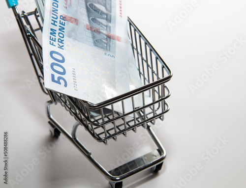 Money of Denmark. Danish kroner bills and supermarket shopping cart. DKK banknotes. 500 kroner. Business, finance, news background. High quality photo photo