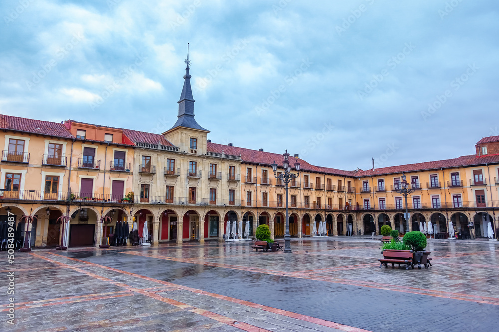 Main square with old buildings and arcades under the houses at sunset, Leon Spain.