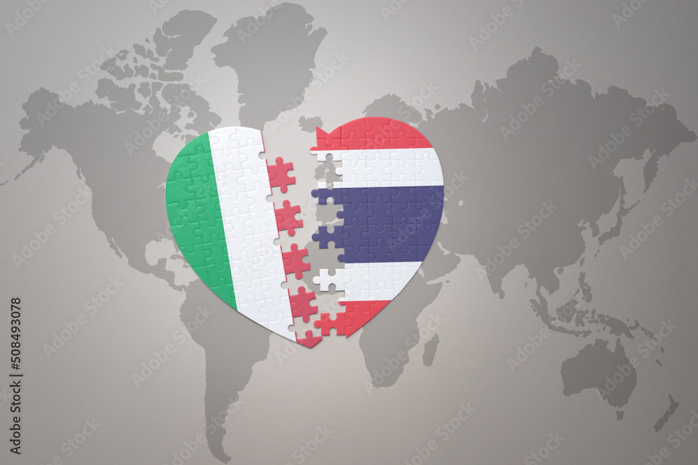 Obraz premium puzzle heart with the national flag of thailand and italy on a world map background. Concept.