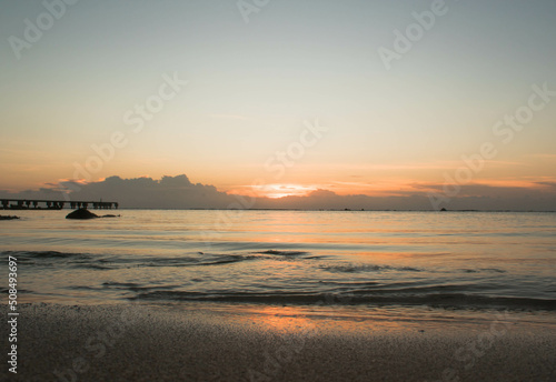 Sunset with warm colors  blue sky and sun reflection on the sand in Tulum 