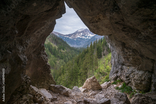 Fototapeta Naklejka Na Ścianę i Meble -  The view from the Mylna cave through the Pawlikowski window on the Koscieliska Valley. Tatra Mountains.