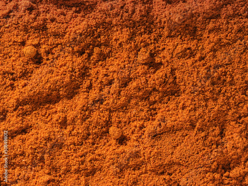 Background texture of chili pepper powder spice used as a spice in cooking. Pile of chili pepper. Organic and tasty dried chili pepper spice. Organic food, healthy lifestyle. Top view, Flat lay 