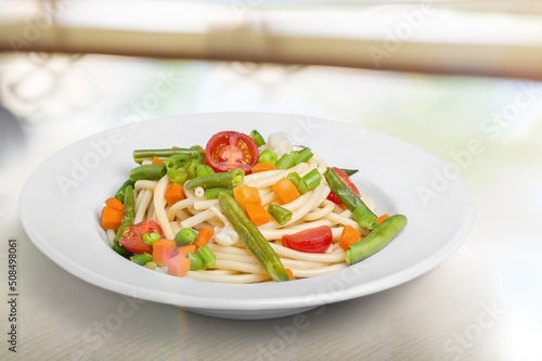 Mix corn pasta with chees and vegetable on plate.